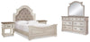 Cama Queen tapizada Realyn con paneles, tocador, espejo y dos mesitas de noche